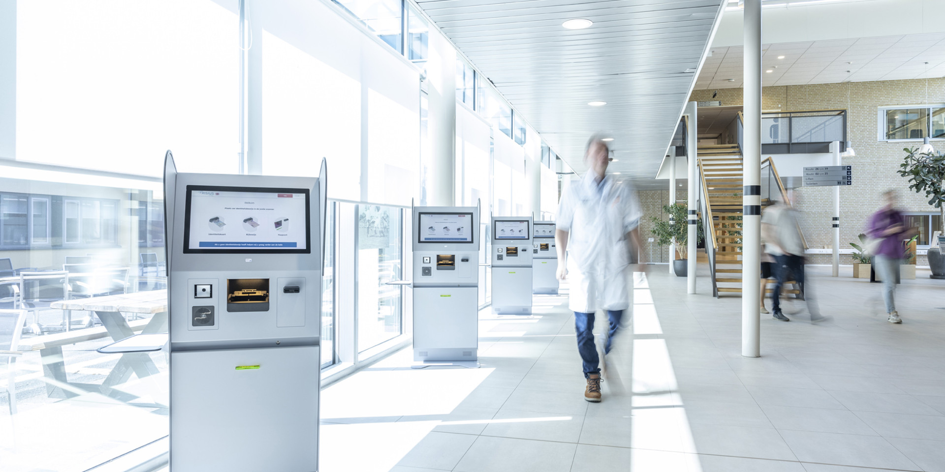 Centrale hal van Frisius MC Heerenveen met een rij van aanmeldschermen